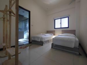 Postel nebo postele na pokoji v ubytování Caiteng B&B