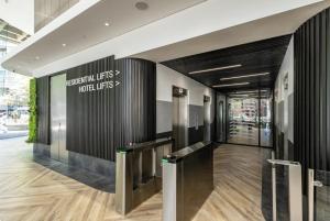 a lobby of a building with a sign on the wall at One Thibault Hotel - Sea View Studio - Near CTICC & V&A Waterfront in Cape Town