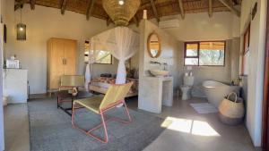 a bathroom with a tub and a toilet and a sink at Tzamenkomst River Lodge in Colesberg +37 photos