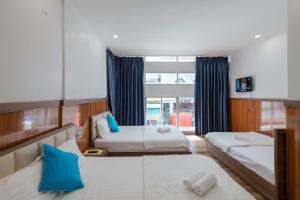 a hotel room with two beds and a window at Khách Sạn HIỆP PHONG in Phú Quốc +27 photos