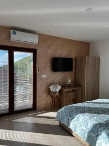 a bedroom with a bed and a television on a wall at Villa Marina in Ohrid