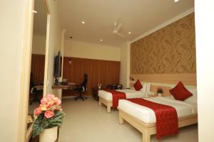 Postel nebo postele na pokoji v ubytování Hotel DSF Grand Plaza