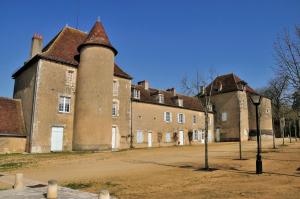 a large brick building with a tower on top of it at Maison calme au pied du Chateau in Le Blanc
