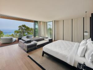 a bedroom with a bed and a couch and a tub at Maxx Royal Bodrum in Golturkbuku +143 photos