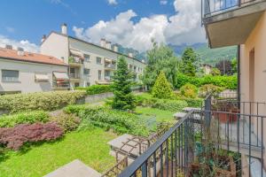 a view of a garden from the balcony of a apartment at Sunflowers Home in Mandello del Lario