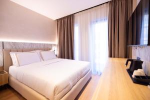 Postel nebo postele na pokoji v ubytování Tris3 Hotel