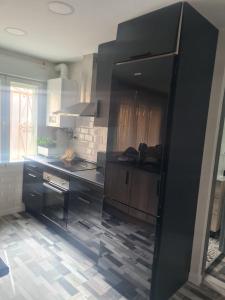 a kitchen with a black refrigerator in a room at Apartamento Soria Calaverón in Soria +6 photos