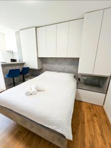 a bedroom with a white bed with white cabinets at TOP - Ljubljana's Central Gem - free public parking in Ljubljana