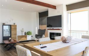 a dining room with a table with chairs and a fireplace at 3 Bedroom Beautiful Apartment In Elche in Elche