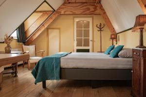 a bedroom with a large bed in a attic at Hotel Groede in Groede