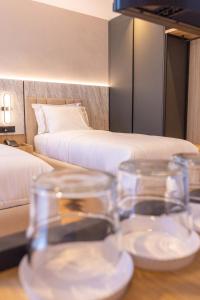 Postel nebo postele na pokoji v ubytování Tris3 Hotel