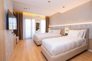Postel nebo postele na pokoji v ubytování Tris3 Hotel