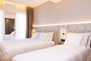 Postel nebo postele na pokoji v ubytování Tris3 Hotel