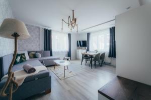 a living room with a couch and a table at Apartmány Friends Liptov in Liptovský Mikuláš