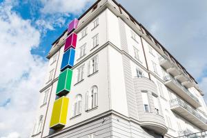 a white building with colorful panels on the side at Hostel Link in Lovran