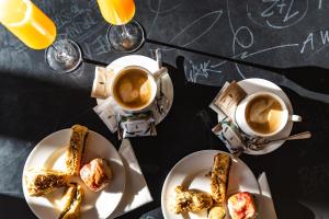 a table with two plates of food and two cups of coffee at Hostel Link in Lovran