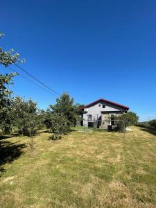a house on a hill with a field and trees at Kuća za odmor Mariola in Karlovac