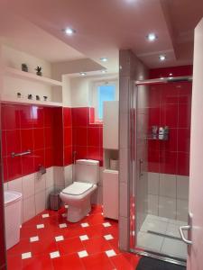 a red bathroom with a toilet and a shower at Kuća za odmor Mariola in Karlovac +25 photos