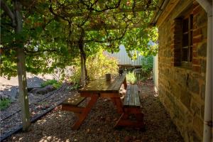 a picnic table and benches under a tree at Spa Bath, Entire Home, Off Street Parking, Barossa Valley in Eden Valley