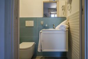 a small bathroom with a toilet and a sink at Nonna Carmela Holiday House in San Lazzaro Agerola +73 photos