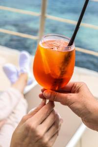 a person holding a drink in their hands at Inmood Aucanada 4 Sup in Port d'Alcudia