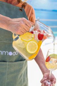 a person pouring a drink in a glass pitcher at Inmood Aucanada 4 Sup in Port d'Alcudia