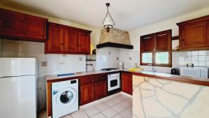 a kitchen with a white refrigerator and a dishwasher at Le Pavillon des Alizés in Gourbeyre +29 photos