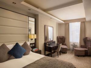 a hotel room with a bed and a desk at Montcalm Brewery, London City in London
