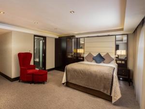 a hotel room with a bed and a red chair at Montcalm Brewery, London City in London