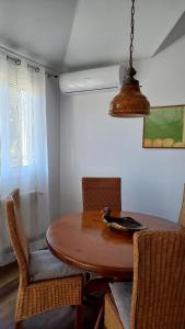 a dining room table with chairs and a bird bowl on it at Апартаменты Вилла Ионика in Kalón Nerón +34 photos