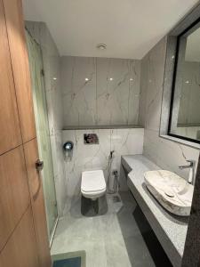 a bathroom with a toilet and a sink at RED CARPET CLASSIC HOSPITALITY LLP in Māndvi