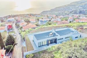 an aerial view of a house with a swimming pool at Vila Cales e Chadas by Your Madeira Rentals in Arco da Calheta