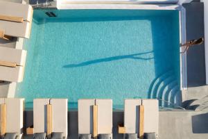 a shadow of a dolphin in a swimming pool at La Perla Villas and Suites - Adults Only in Oia
