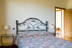 a bedroom with a large bed with a floral bedspread at Il Borgherino in Cerreto Guidi