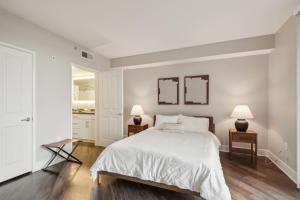 a white bedroom with a large bed and two lamps at Sunny 3BR Santa Monica Retreat with Pool,Jacuzzi & Parking! in Santa Monica +17 photos