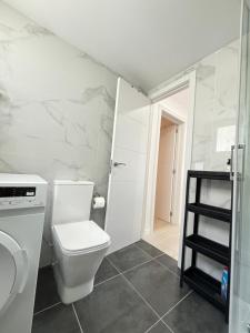 a bathroom with a toilet and a shelf in it at Casa Francisca 100 mt from the beach By lucaproperties in Puerto Rico de Gran Canaria +13 photos