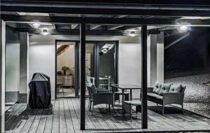 a patio with a table and chairs and a dining room at Amazing Home In Staniszów With Wifi in Staniszów