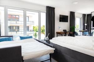 En eller flere senge i et værelse på MOONLIVING Boutique Apartments by Munich