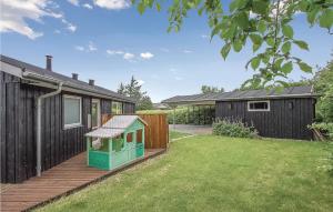 a backyard with a wooden deck and a house at Awesome Home In Vinderup With Wifi in Vinderup