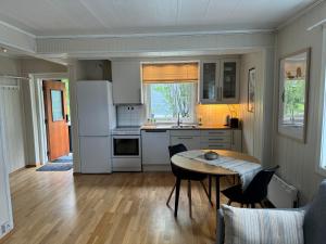 a kitchen with a table and chairs in a room at WALO APARTMENTS TROMSDALEN - Close to cable car and Arctic Cathedral, 10 min by bus to city centre, Free parking in Tromsø