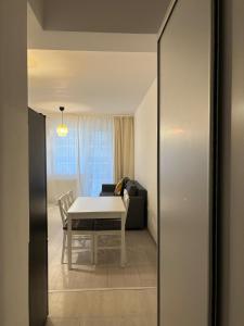 a living room with a table and a couch at Velvet Breeze Apartment in Năvodari