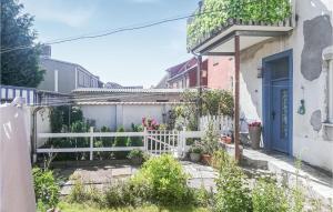 a white fence in front of a house at 1 Bedroom Nice Apartment In Barth in Barth