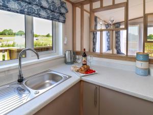 a kitchen counter with a sink and a window at Aspen Lodge in Whitby