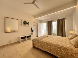 a large bedroom with a bed and a mirror at Casa Oda Seaview in Puerto del Carmen +18 photos