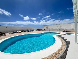 a swimming pool on the side of a building at Casa Oda Seaview in Puerto del Carmen