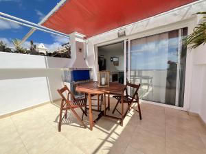 a table and two chairs on a balcony with a table at Casa Oda Seaview in Puerto del Carmen