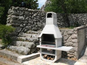 a stone wall with a pizza oven in front of it at Ferienhaus für 6 Personen ca 50 m in Jablanac, Adriaküste Kroatien Kvarner Bucht in Jablanac