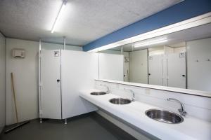 a bathroom with two sinks and a large mirror at Landgut Girtenmühle in Britten +45 photos