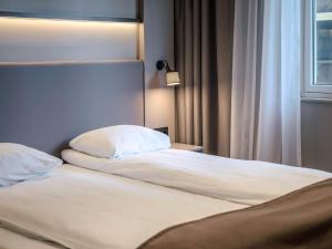 Postel nebo postele na pokoji v ubytování Quality Hotel Saga