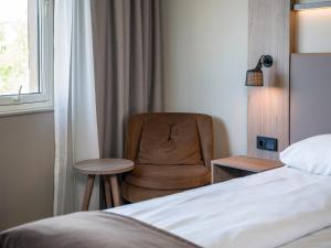 Postel nebo postele na pokoji v ubytování Quality Hotel Saga